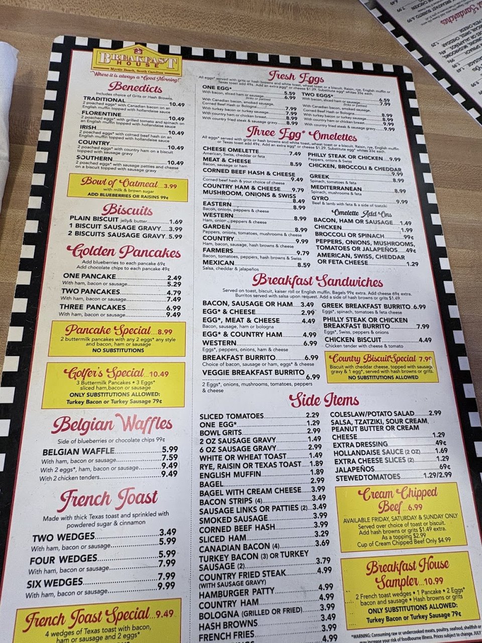 Burgers, dogs, and chili listed on menu boards.